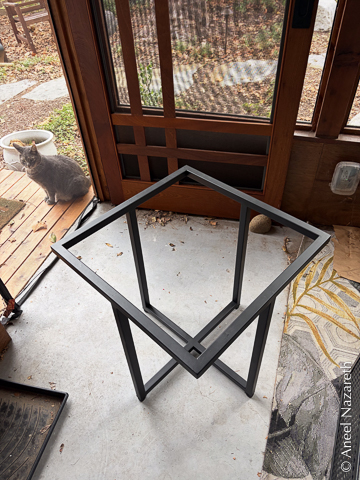 This base has four vertical legs, but only one X cross at the bottom and a square at the top